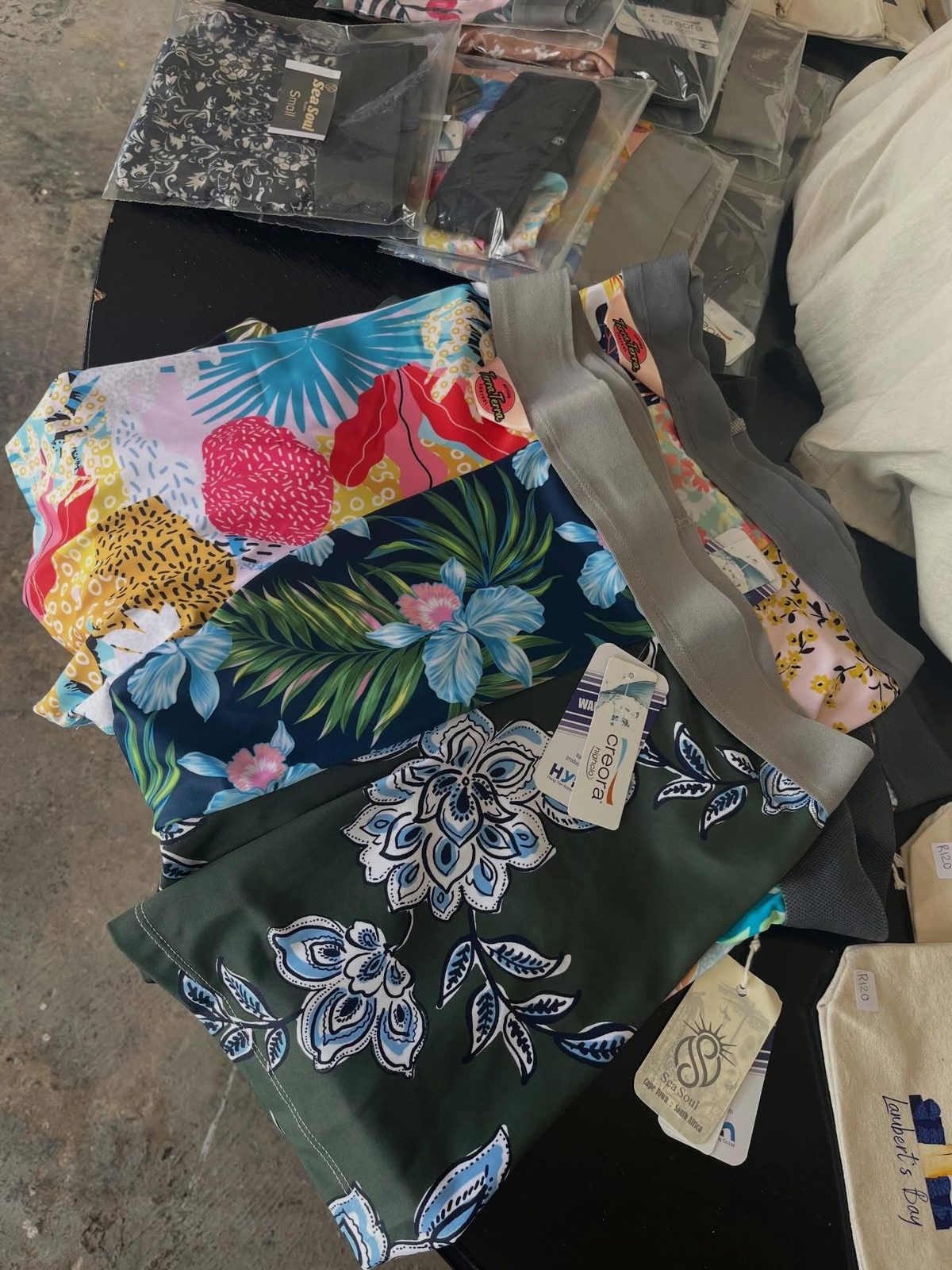 Flat lay of colourful printed swimwear fabrics and offcuts
