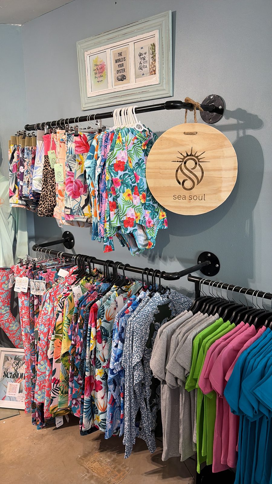 Sea Soul swimwear on a shop rail with a round wooden Sea Soul sign